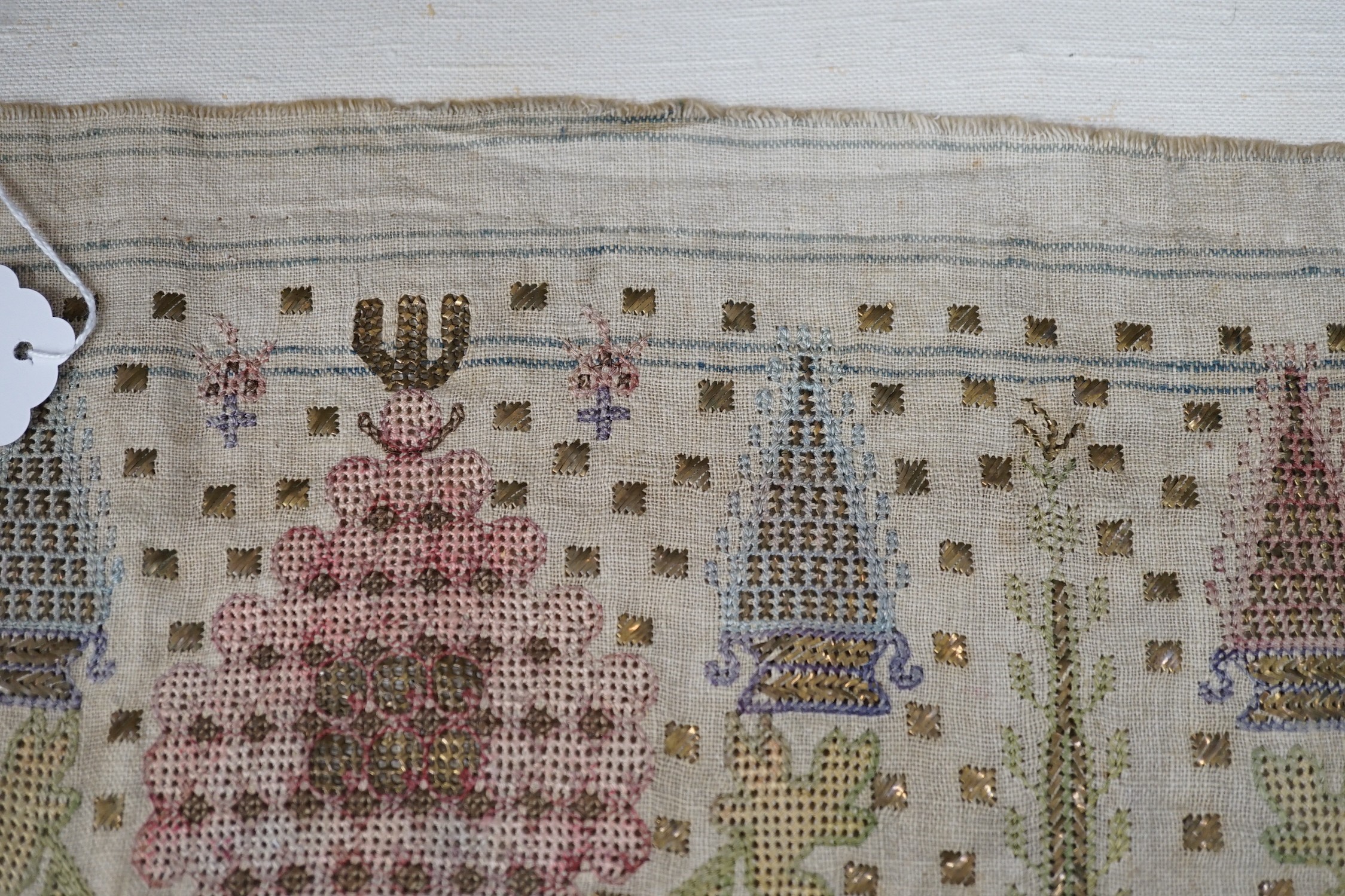 Two 19th century embroidered Turkish towel ends, one framed, 46cms wide x 30cms high